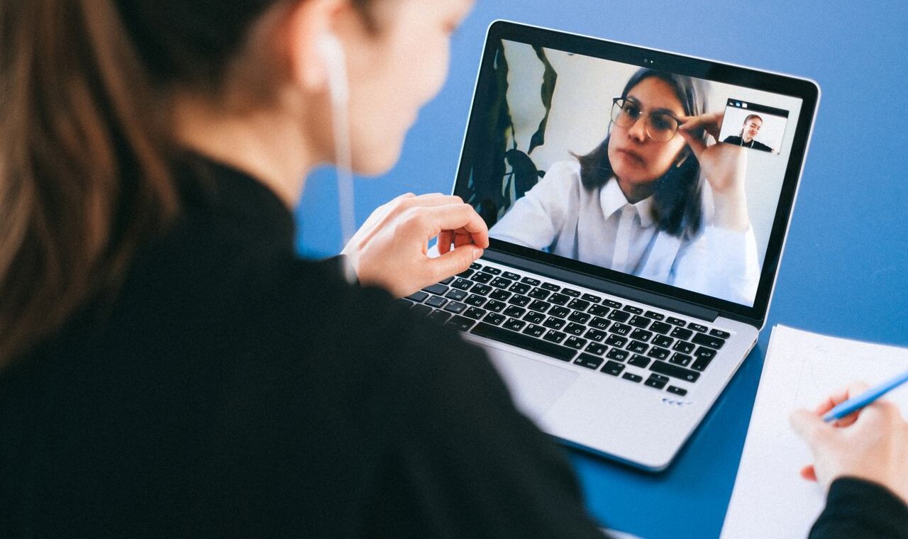 Online video meeting on a laptop screen