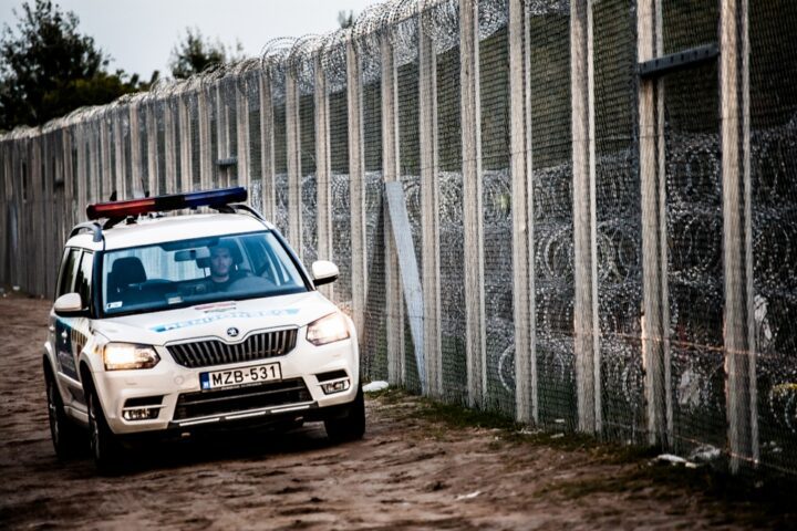Police car at a border barrier