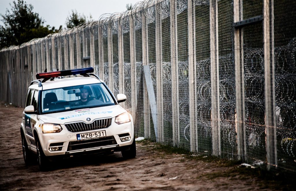 Police car at a border barrier